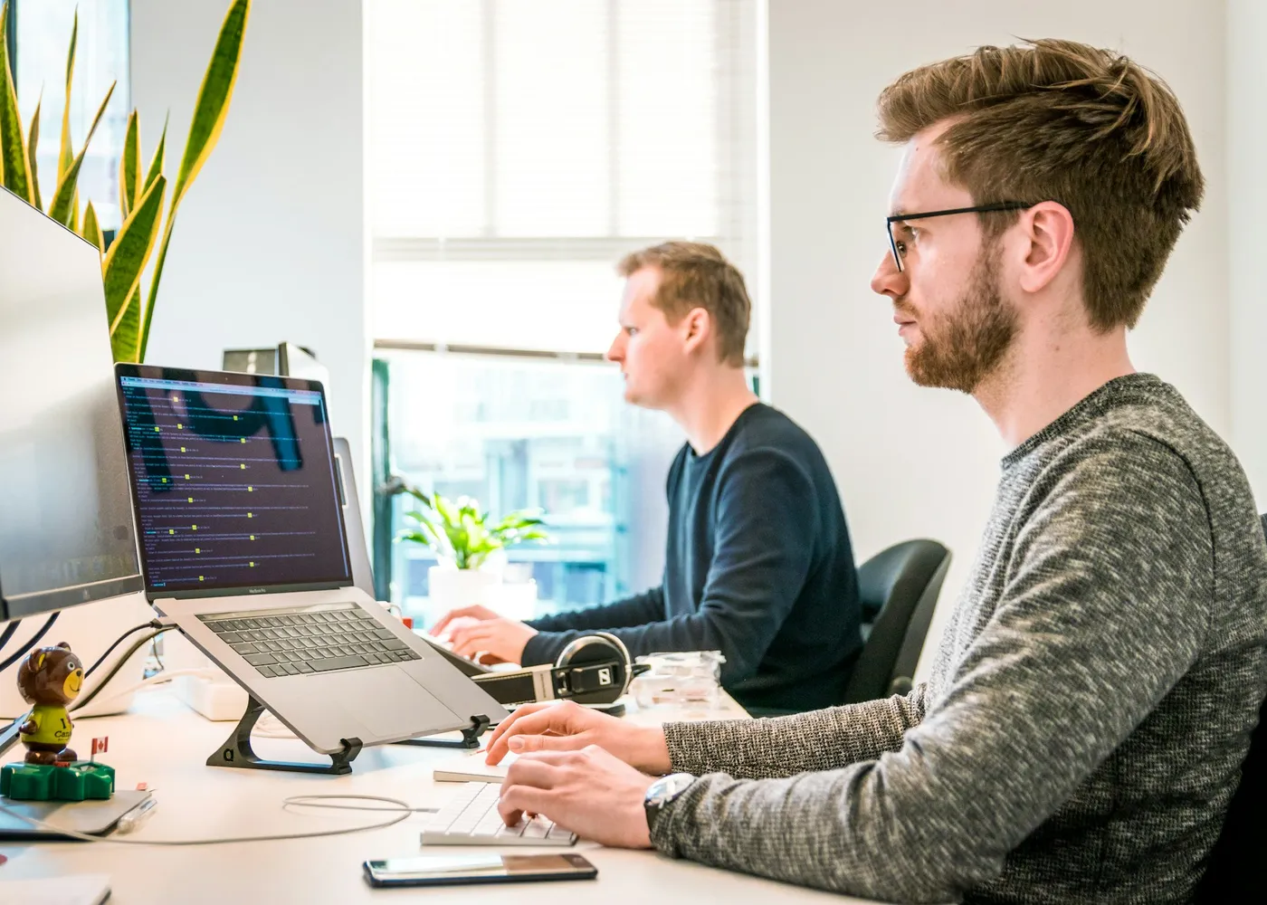 A small product and engineering team working together at a shared desk